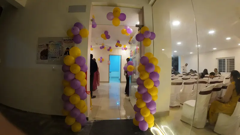 The entrance of Ekreeti Creatives decorated with purple and yellow balloons on opening day
